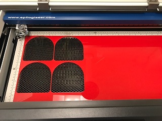 Some pre-cut acrylic placed into the laser cutter